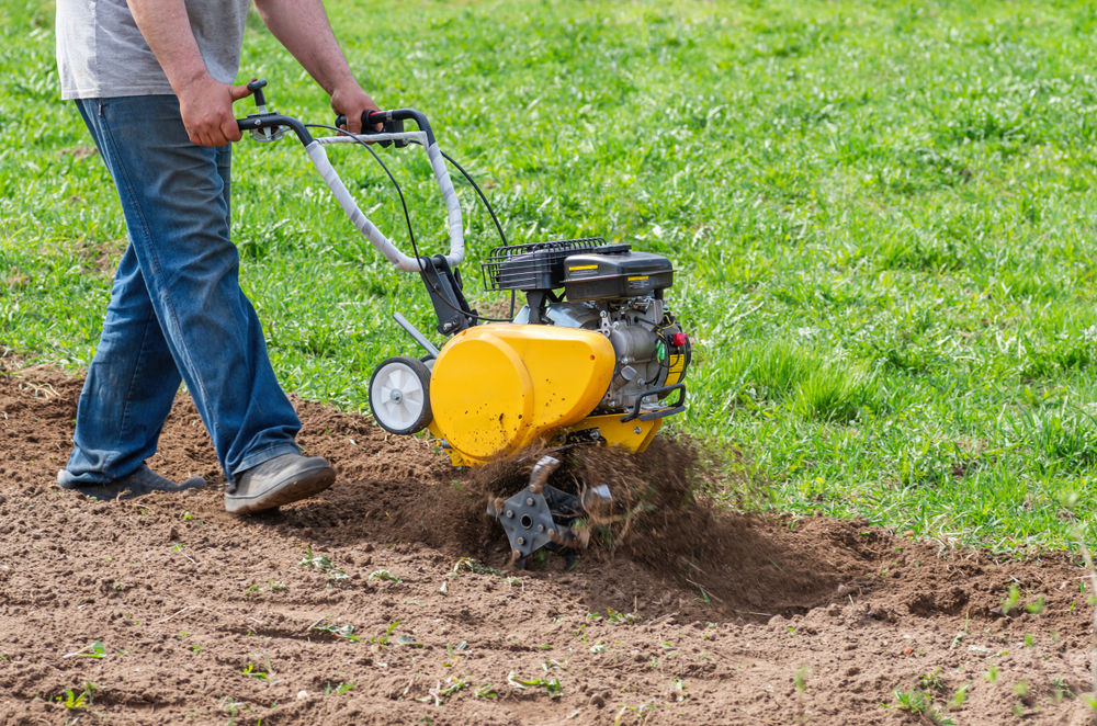 Man,farmer,plows,the,land,with,a,cultivator.,agricultural,machinery: